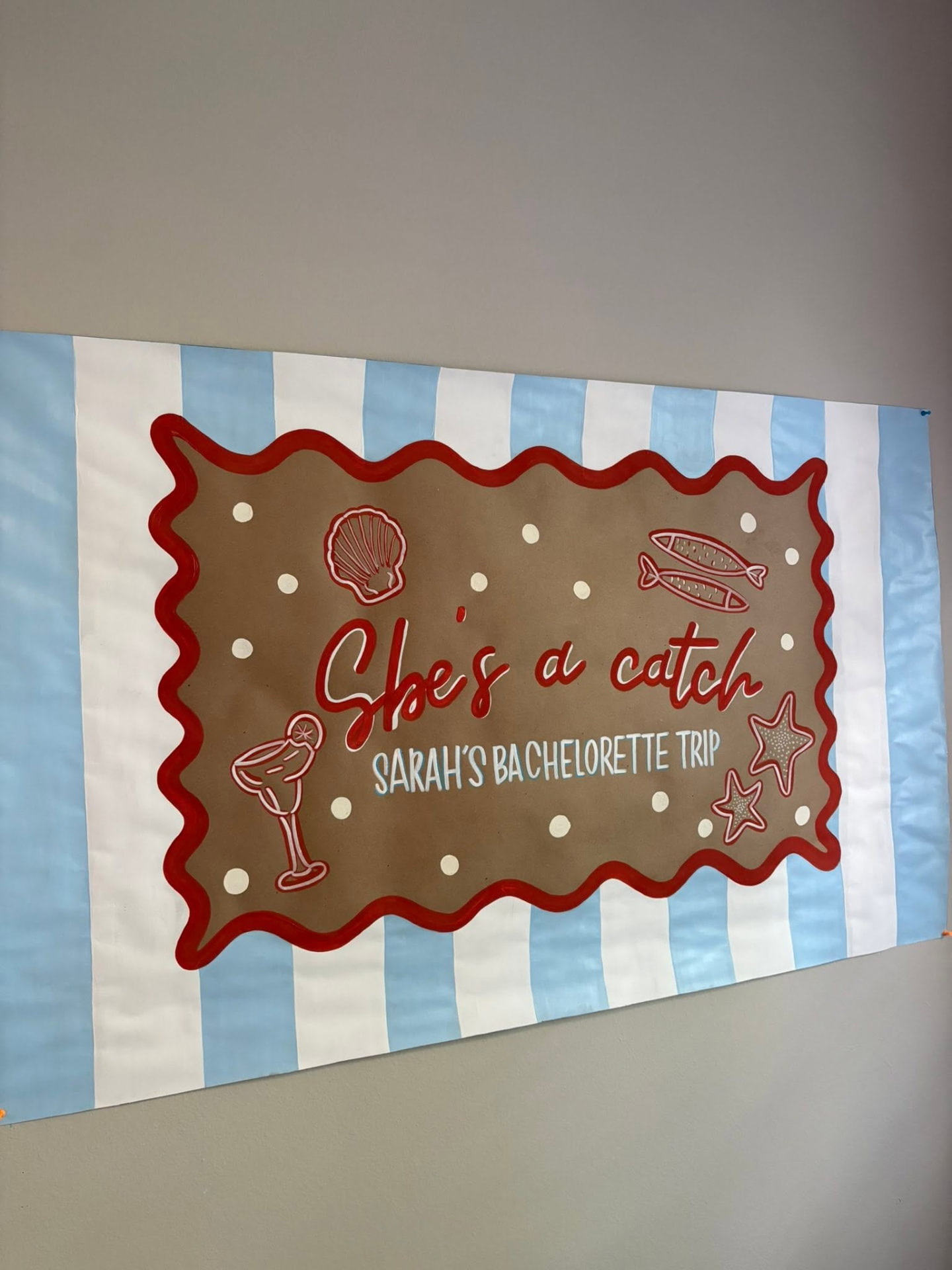 Hand-painted coastal bachelorette banner reading She's a catch